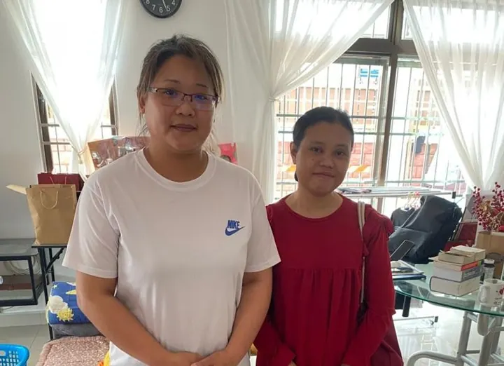 Michelle's helper with a family member at home